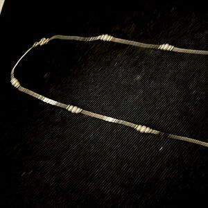 Then silver necklace with little white pearls very long